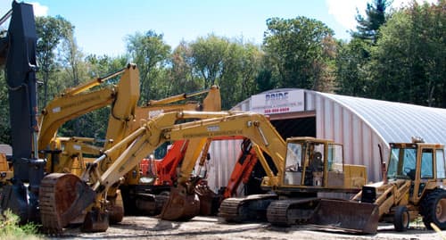 Pride Environmental & Construction equipment yard with excavators and heavy equipment