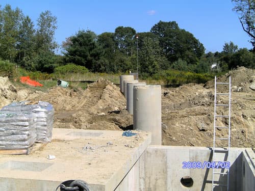 Precast concrete pipe sections staged along a project site